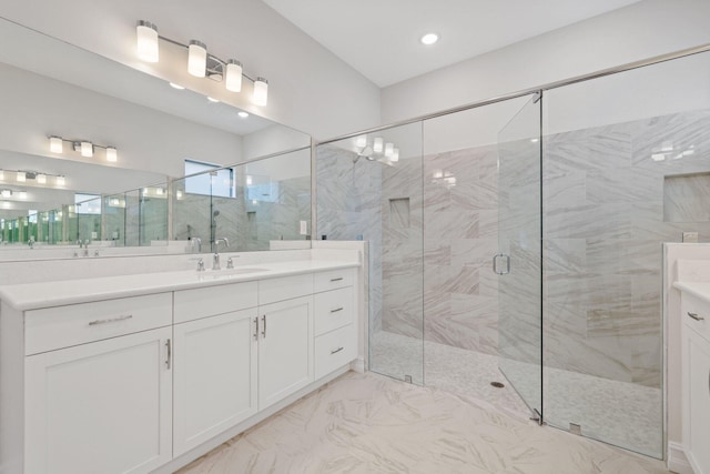 bathroom featuring walk in shower and vanity