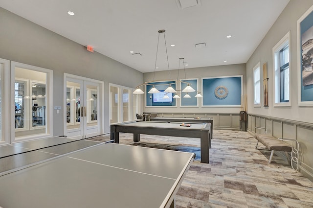 game room featuring pool table, french doors, and light hardwood / wood-style flooring