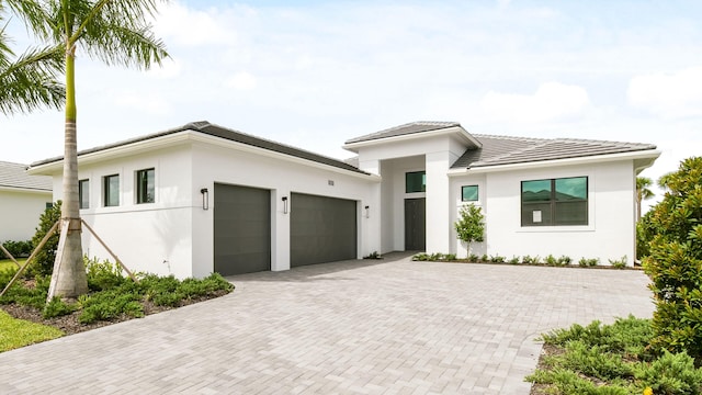 5237 Saint Vincent Ln, Westlake, FL 33470 - view of front facade with an attached garage, decorative driveway, stucco siding, and a tiled roof