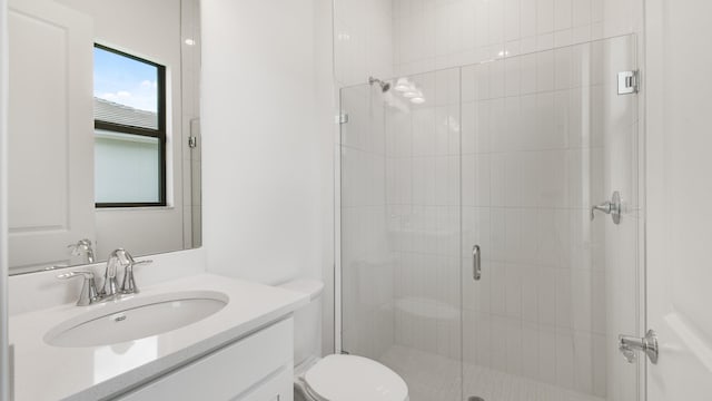 bathroom featuring walk in shower, vanity, and toilet