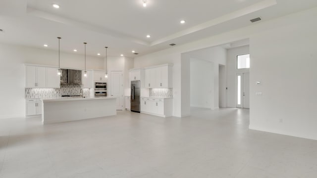 5237 Saint Vincent Ln, Westlake, FL 33470 - unfurnished living room with recessed lighting, a raised ceiling, and a towering ceiling