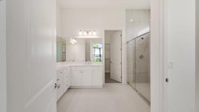 bathroom featuring tile patterned floors, vanity, and a shower with shower door