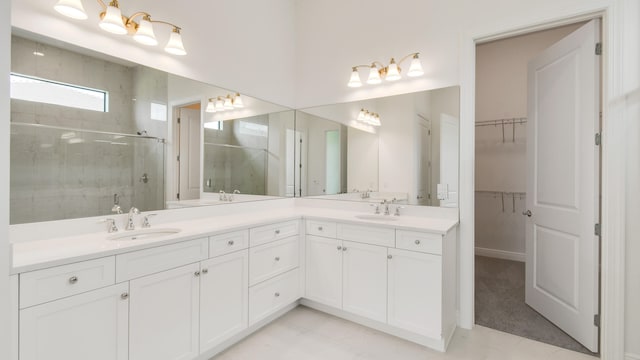 bathroom with vanity and a shower with shower door