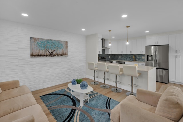 living room with light hardwood / wood-style floors and sink