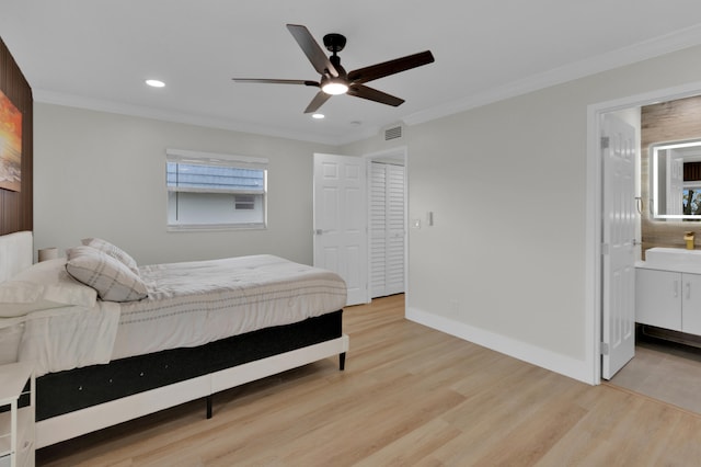 bedroom with ceiling fan, light hardwood / wood-style flooring, multiple windows, and ensuite bath