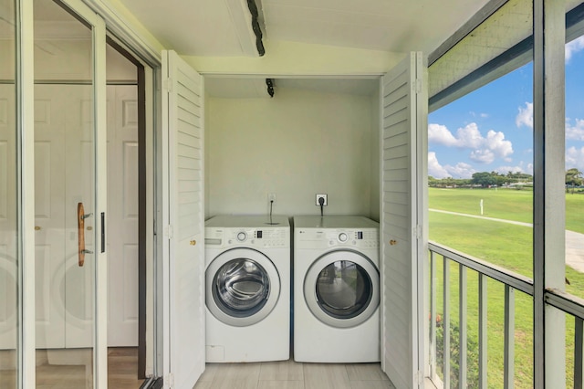 washroom featuring light hardwood / wood-style flooring and washer and clothes dryer