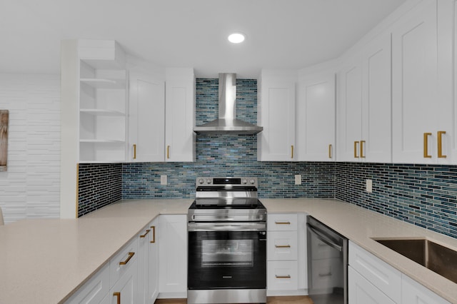 kitchen featuring white cabinets, wall chimney exhaust hood, and stainless steel appliances