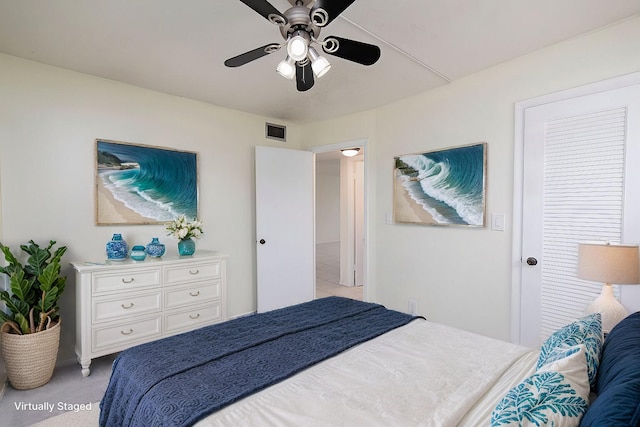 bedroom with ceiling fan and light carpet