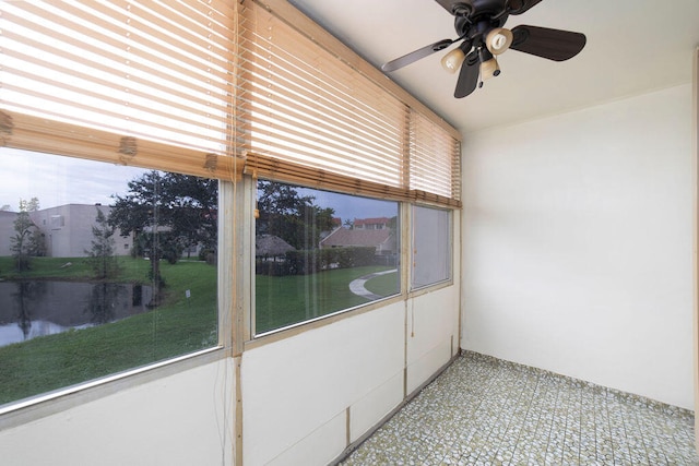 unfurnished sunroom featuring ceiling fan