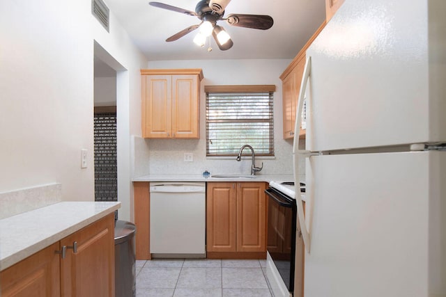 kitchen with light tile patterned flooring, ceiling fan, white appliances, and sink