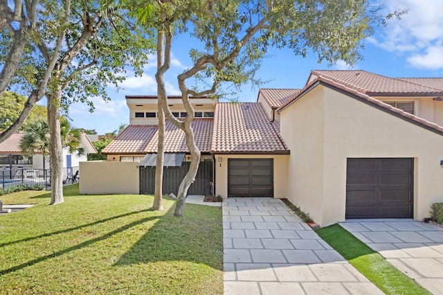 view of front of house featuring a garage and a front lawn