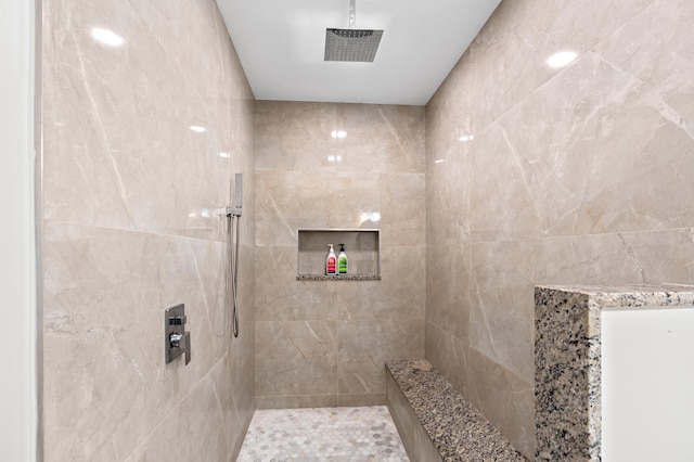 bathroom with tiled shower