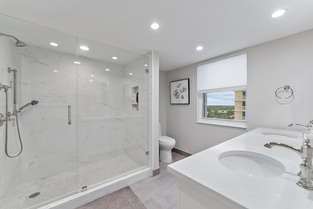 bathroom with toilet, tile patterned flooring, a shower with door, and vanity