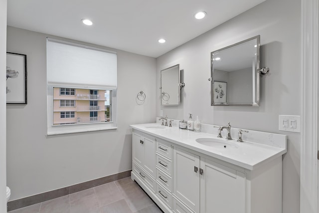 bathroom featuring toilet, tile patterned floors, and vanity