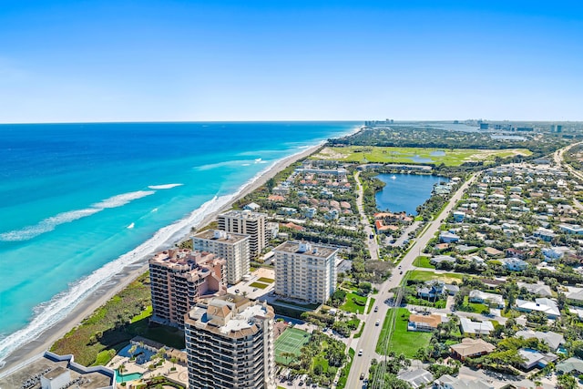 drone / aerial view featuring a water view and a view of the beach