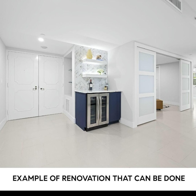 bar featuring blue cabinets, backsplash, and wine cooler