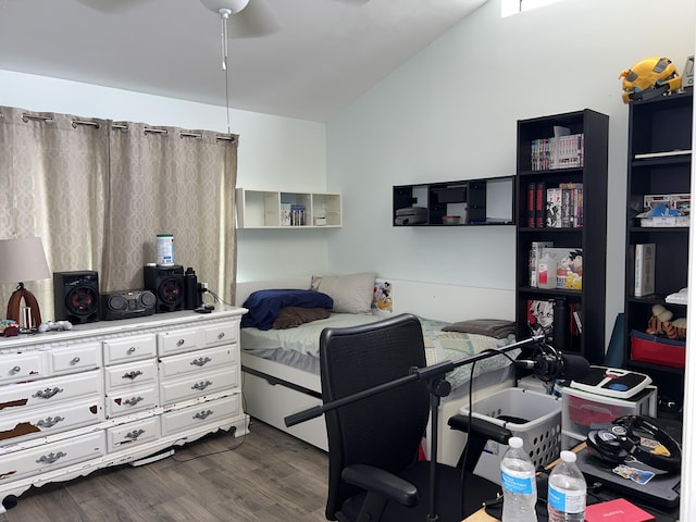 bedroom with dark wood-type flooring, vaulted ceiling, and a ceiling fan