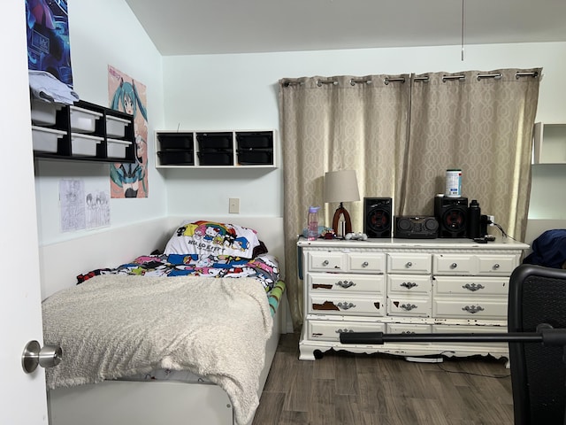 bedroom with dark wood-style floors