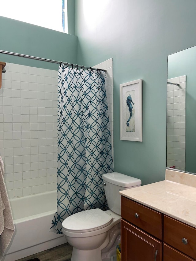 full bathroom with shower / bath combo with shower curtain, vanity, hardwood / wood-style floors, and toilet