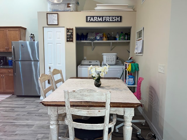 dining room with light hardwood / wood-style floors and independent washer and dryer