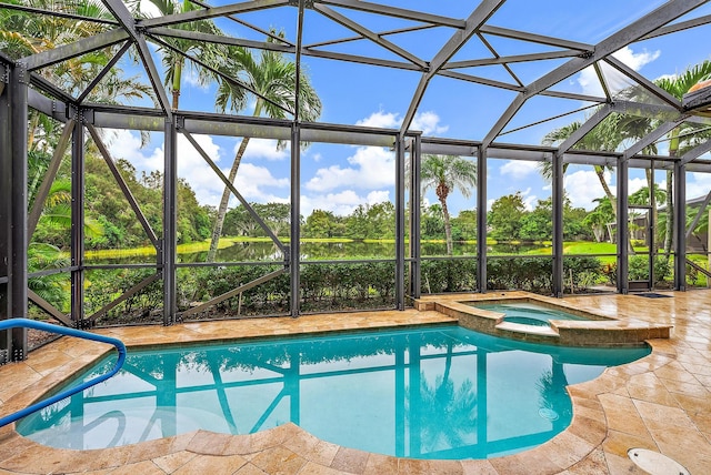 view of pool with a lanai, an in ground hot tub, and a patio area