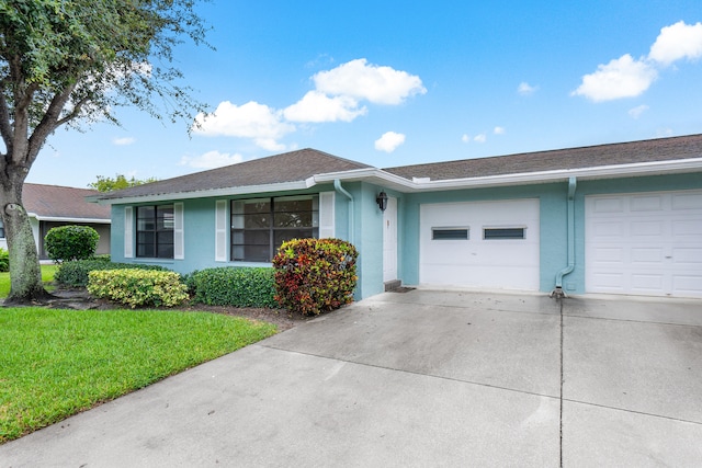 ranch-style home featuring a garage and a front lawn