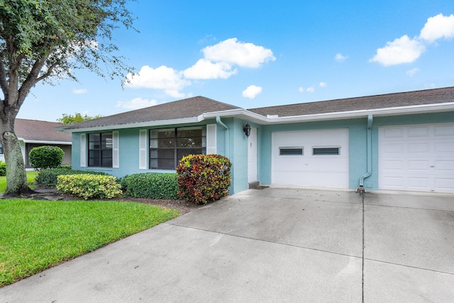 4360 Eucalyptus Tree Ct Unit A, Boynton Beach, FL 33436 - ranch-style home with a garage, a front lawn, roof with shingles, stucco siding, and concrete driveway