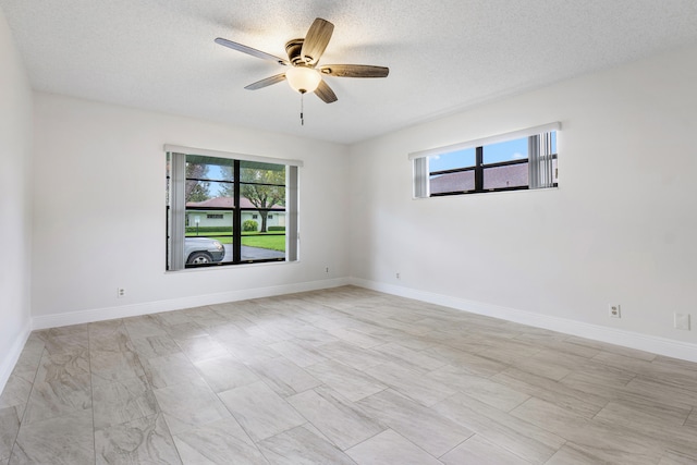 spare room featuring ceiling fan and a textured ceiling