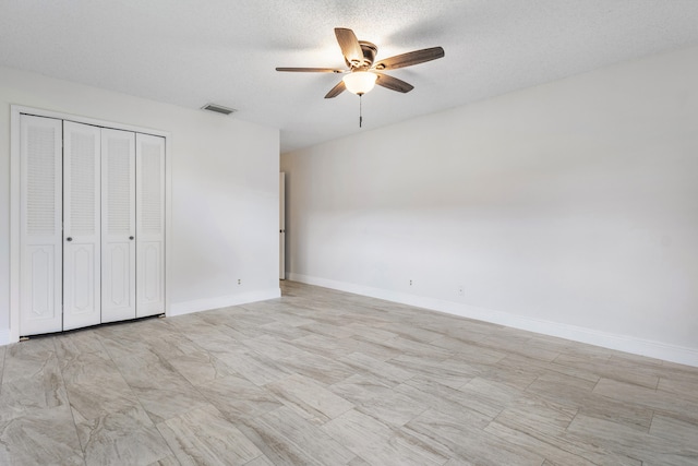 unfurnished bedroom featuring a closet, a textured ceiling, and ceiling fan