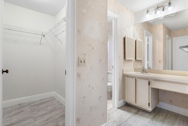 4360 Eucalyptus Tree Ct Unit A, Boynton Beach, FL 33436 - bathroom featuring vanity, baseboards, toilet, and a spacious closet