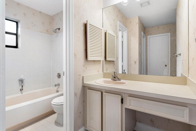 full bathroom with shower / bathing tub combination, tile patterned floors, vanity, and toilet