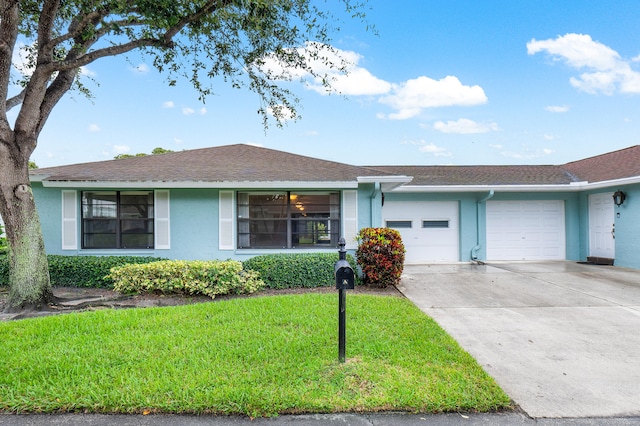 ranch-style house with a garage and a front lawn