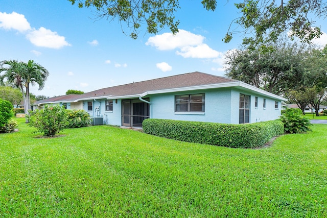 4360 Eucalyptus Tree Ct Unit A, Boynton Beach, FL 33436 - rear view of house with stucco siding, a yard, and cooling unit