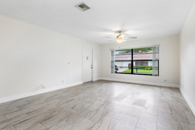 spare room featuring ceiling fan and a textured ceiling