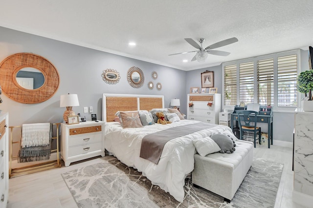 bedroom with ceiling fan, ornamental molding, and a textured ceiling