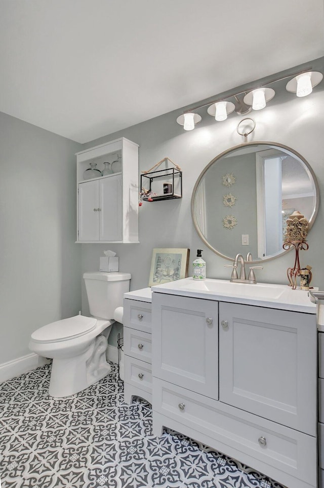 bathroom featuring tile patterned flooring, vanity, and toilet