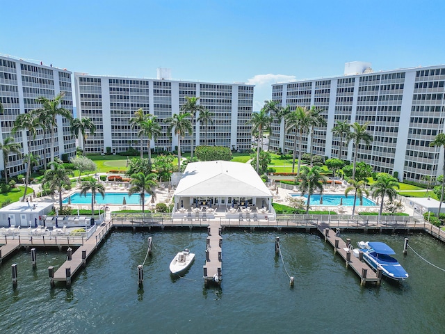 exterior space with a community pool and a water view