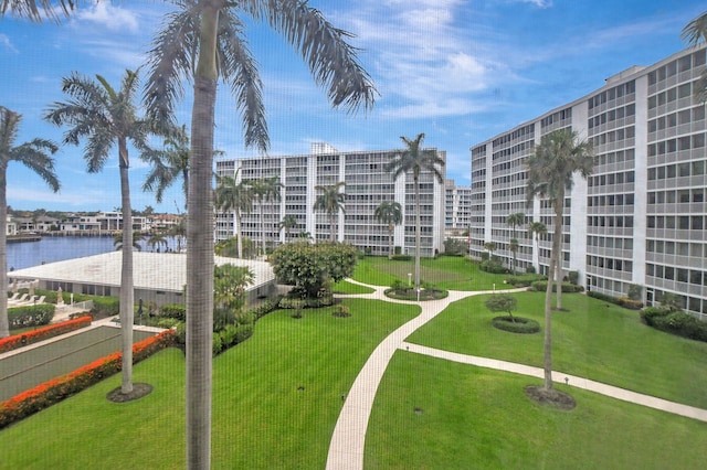 view of community with a water view and a lawn