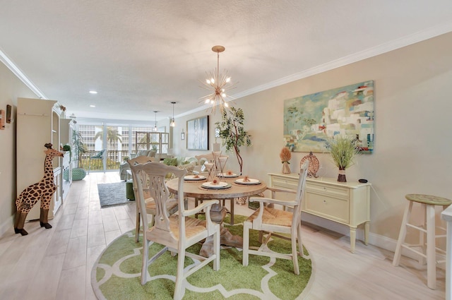 dining room with a textured ceiling, light wood-type flooring, crown molding, and a notable chandelier