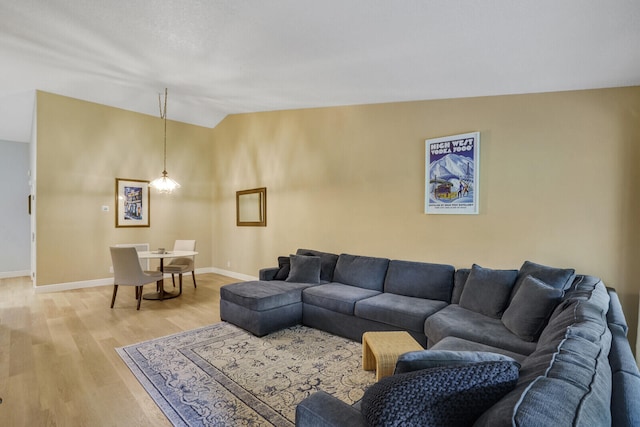 living room with lofted ceiling and hardwood / wood-style flooring