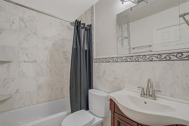 full bathroom featuring vanity, shower / bath combination with curtain, toilet, and tile walls