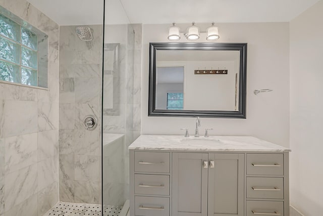 bathroom with vanity and tiled shower