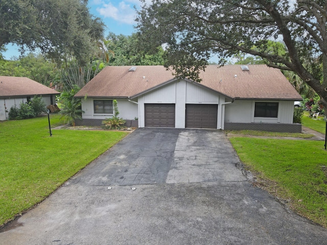 single story home featuring a garage and a front lawn