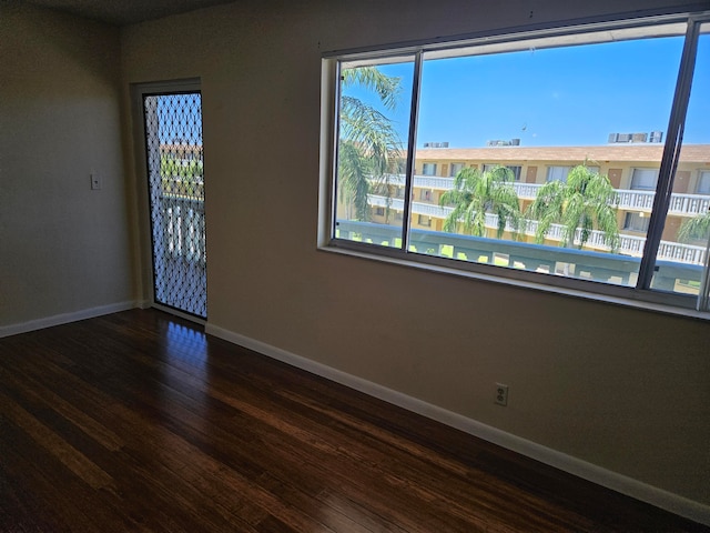 spare room featuring dark wood-type flooring