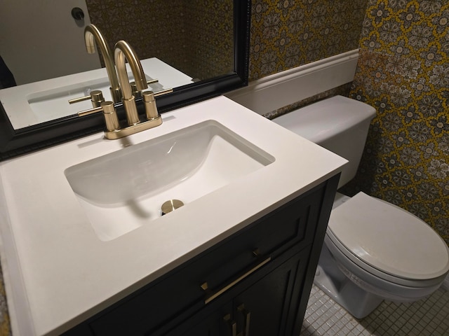 bathroom with tile patterned floors, vanity, and toilet