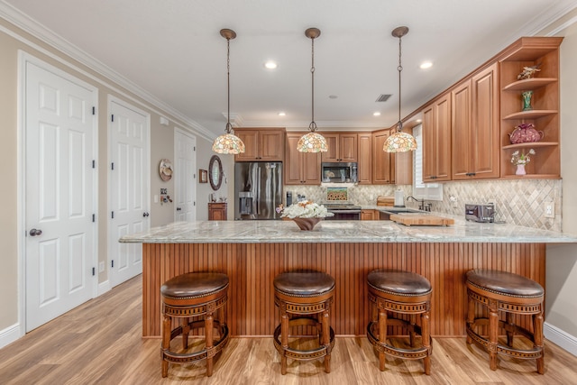 kitchen featuring kitchen peninsula, crown molding, appliances with stainless steel finishes, and light wood-type flooring