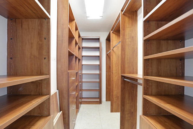 spacious closet featuring light tile patterned flooring