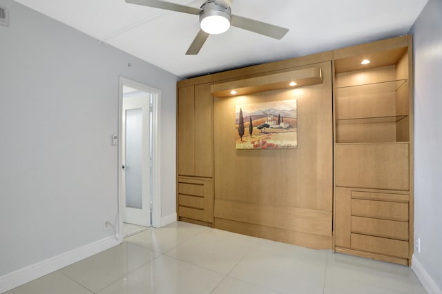 interior space with tile patterned floors and ceiling fan