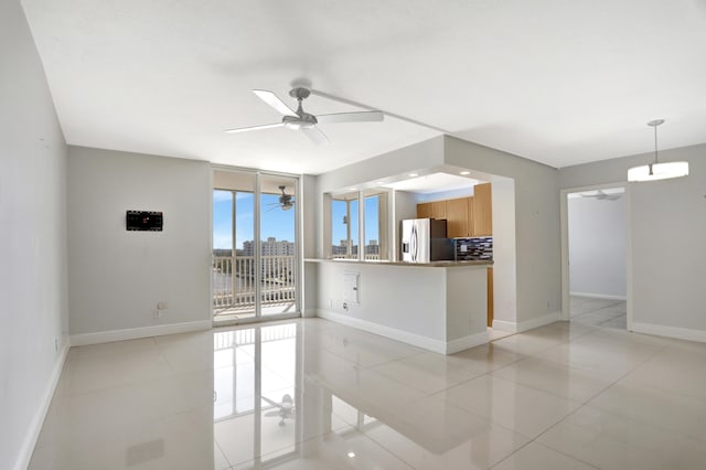 tiled spare room with ceiling fan