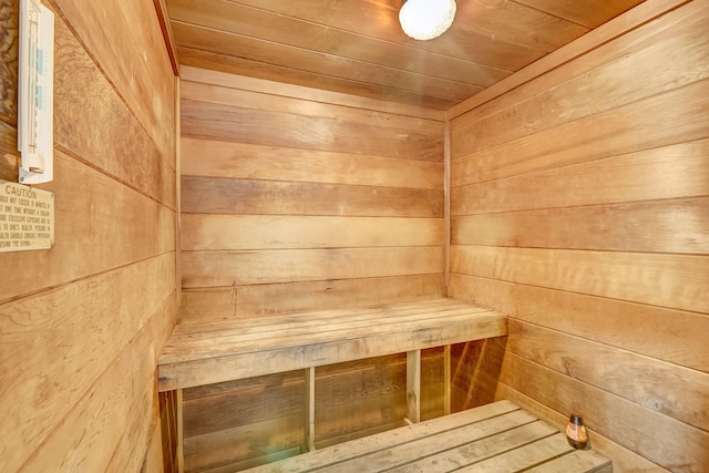 view of sauna / steam room with wood walls and wood ceiling